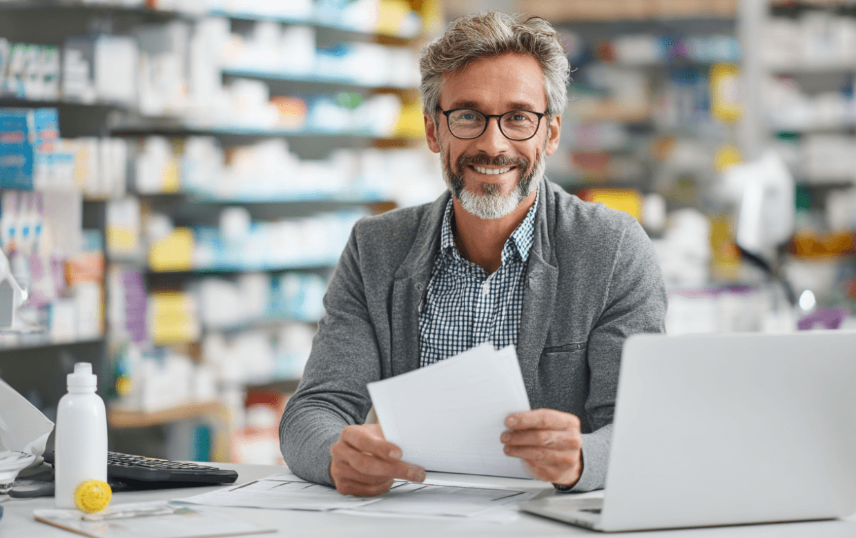 pharmacy owner smiling with funding approval documents
