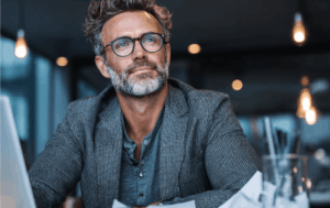 Business owner reviewing Q1 tax payment documents and financial statements at desk