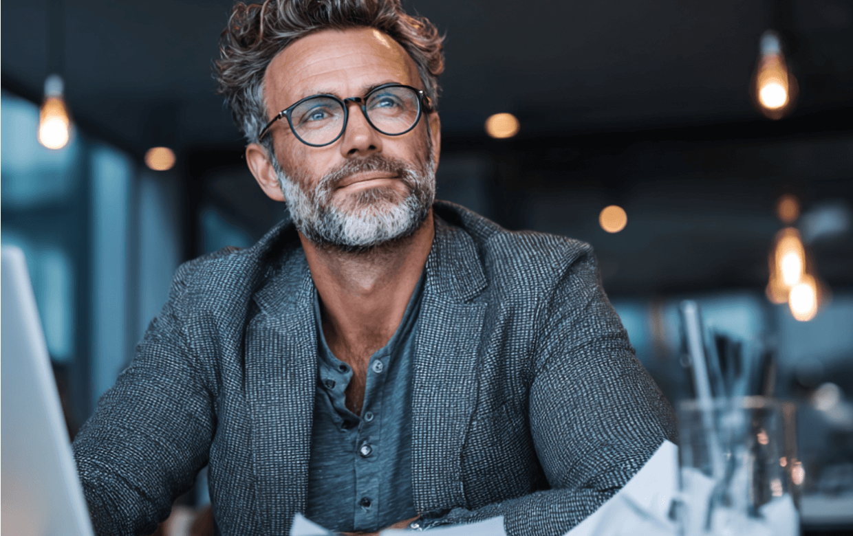 Business owner reviewing Q1 tax payment documents and financial statements at desk